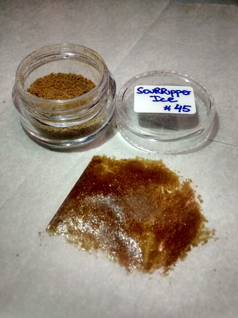 Bubble hash de la variedad SourRipper Ice #45 de Ripper Seeds: polvo de tricomas en contenedor y pieza prensada sobre papel